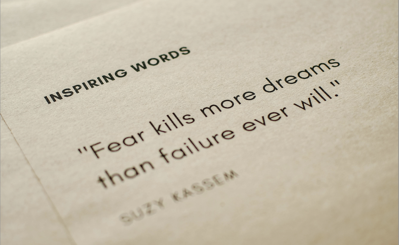 Black text on cream colored paper background that reads INSPIRING WORDS "Fear kills more dreams than failure ever will" SUZY KASSEM