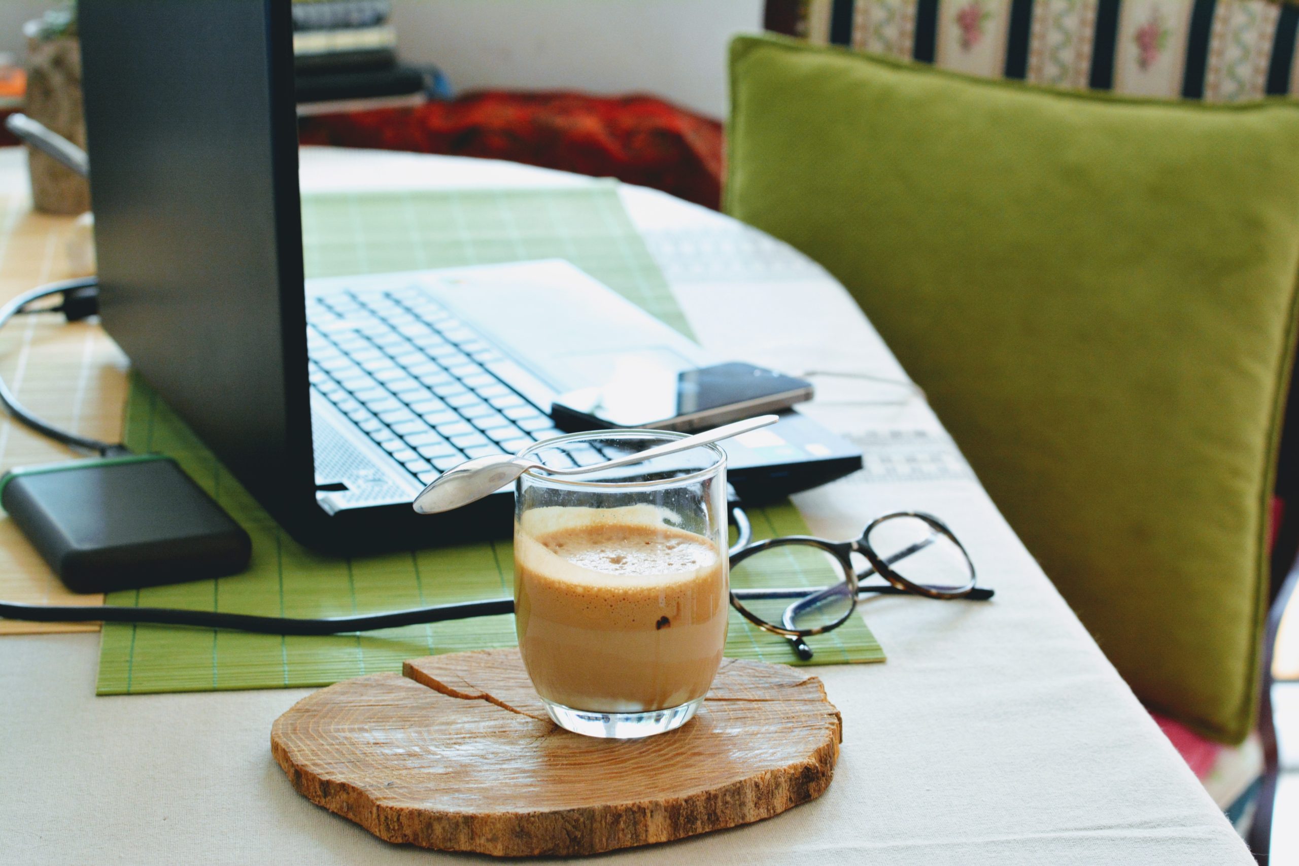 computer, cup of coffee, glasses, on a desk