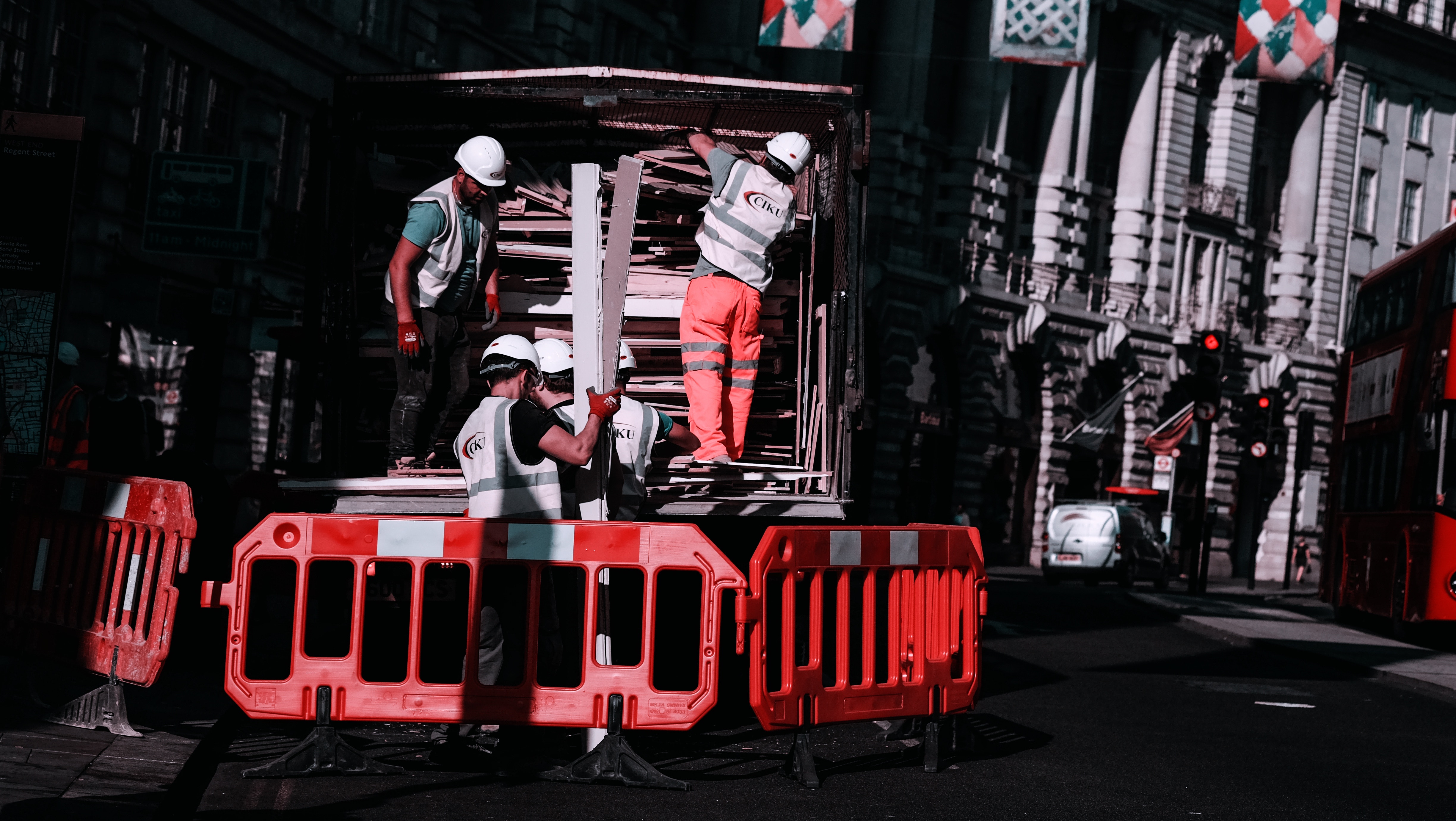 Construction workers assembling barriers