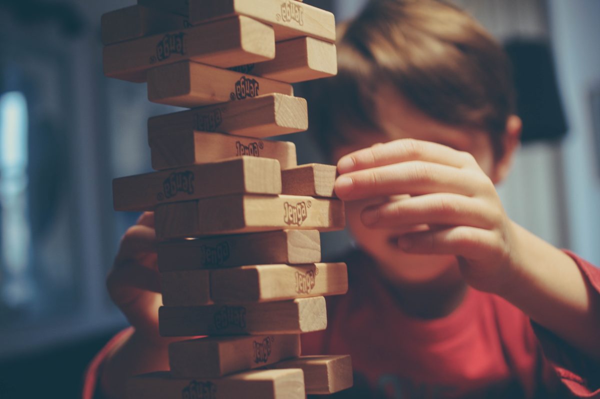 little boy playing Jenga