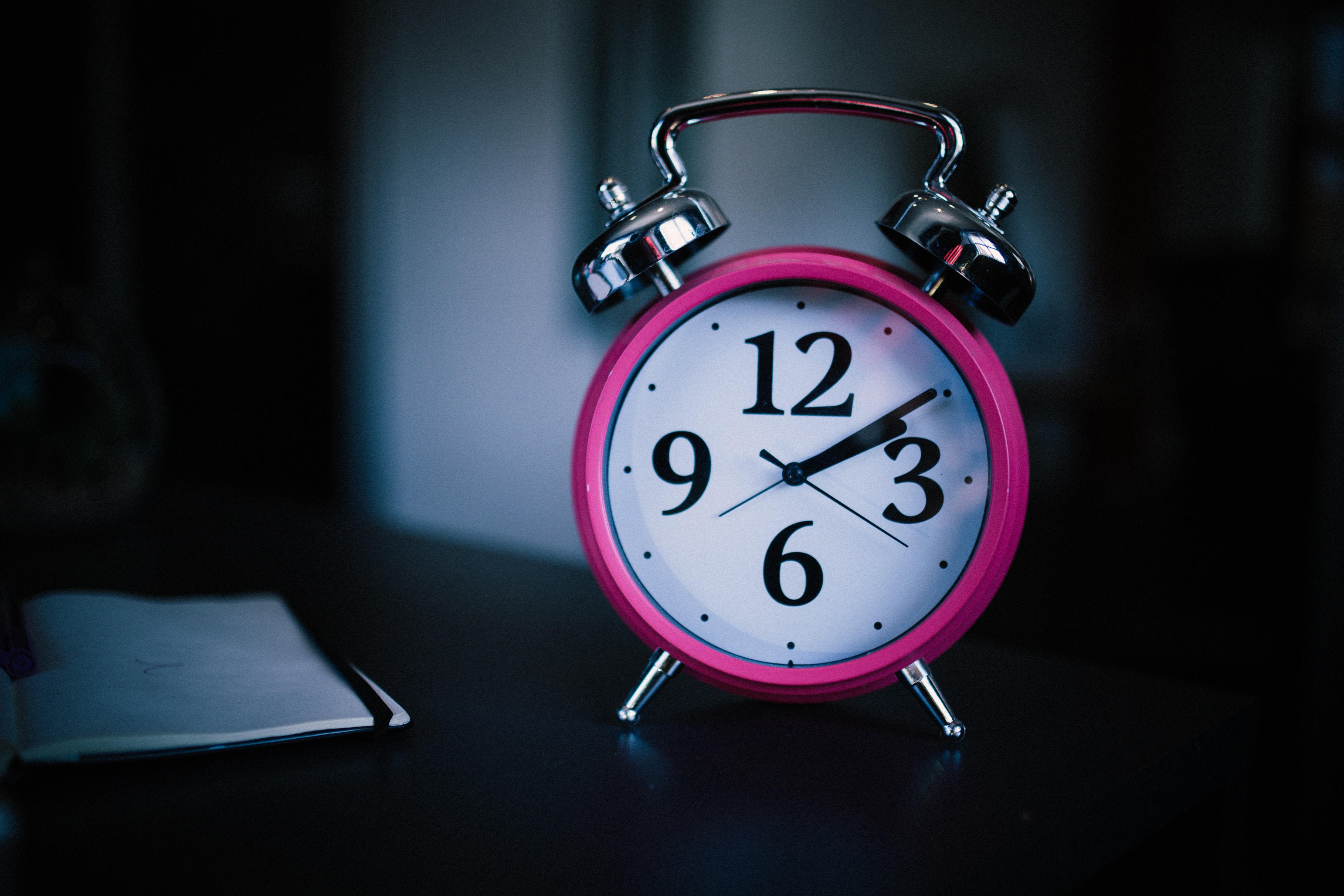 pink alarm clock on a table